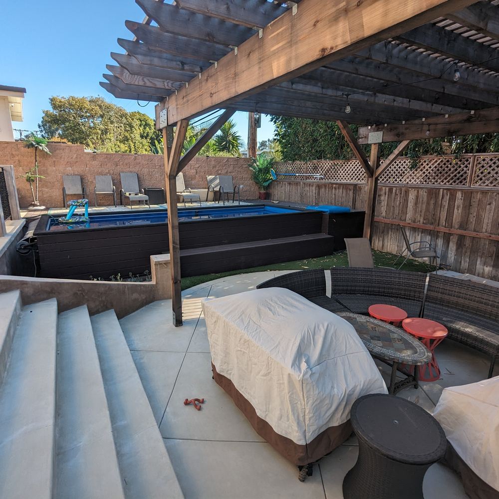 Concrete steps down to a plunge pool and lounge area
