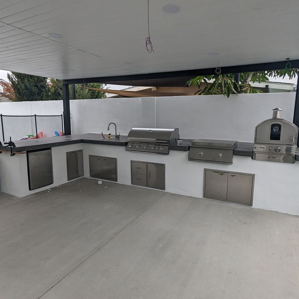 Covered outdoor kitchen on a concrete patio