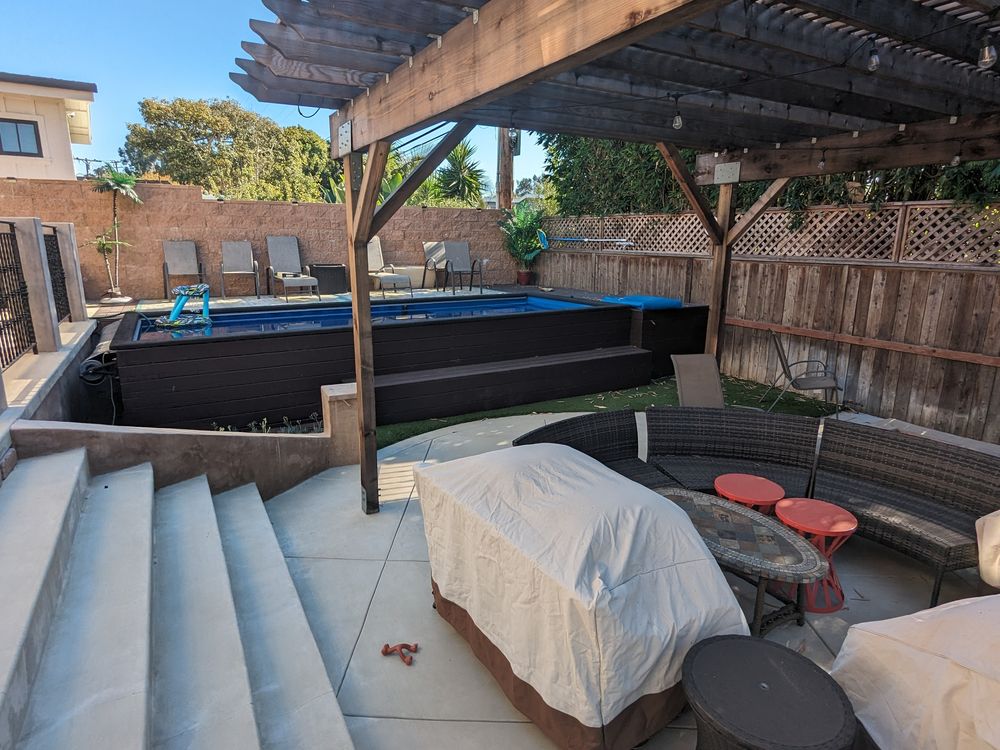 Concrete steps down to a plunge pool and lounge area