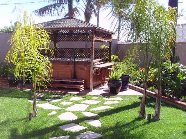 Garden with stepping stones, lawn and a gazebo