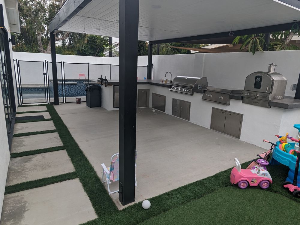 Turf with concrete stepping pads leading to a covered patio